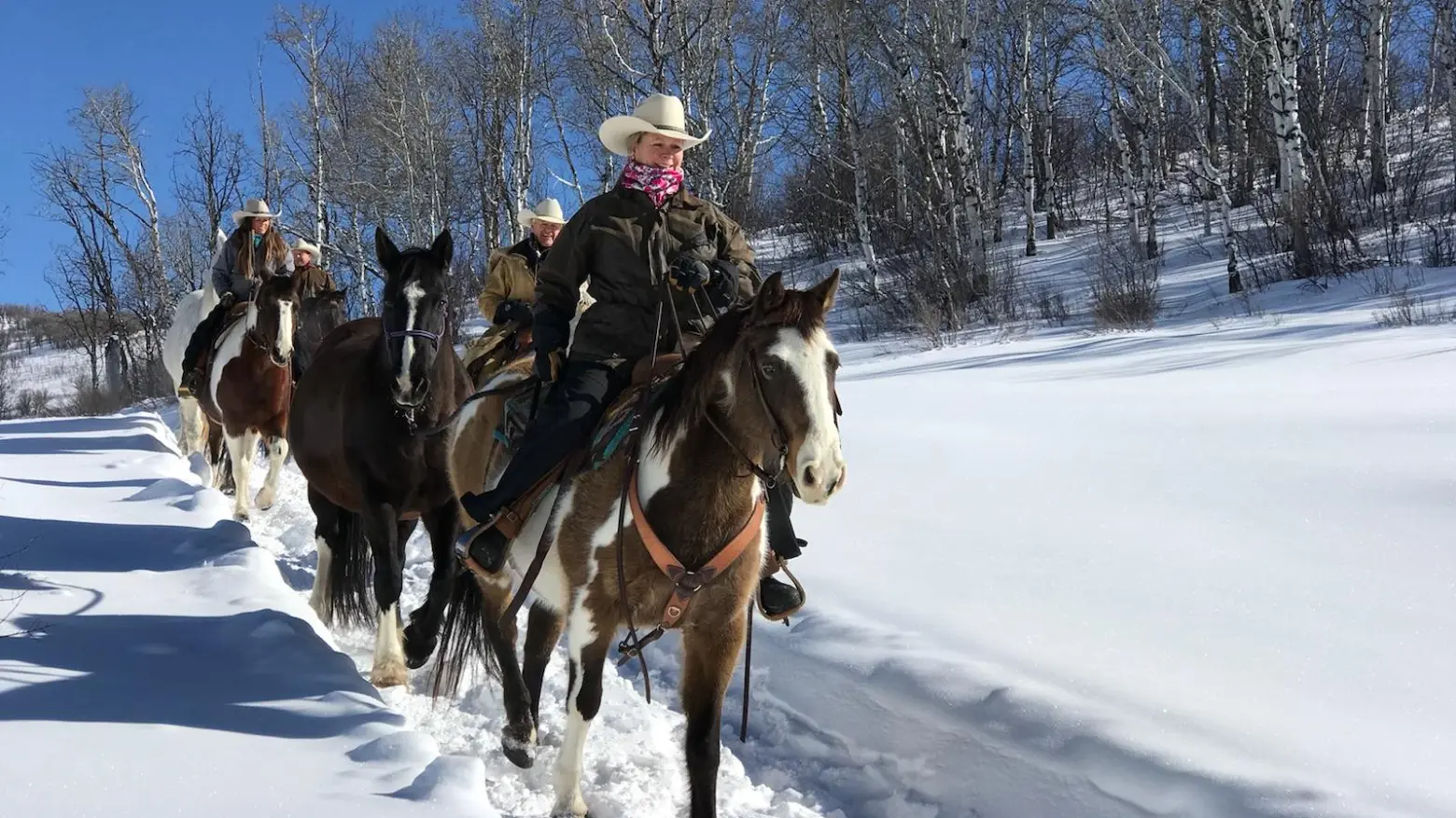 a man riding a horse in the snow